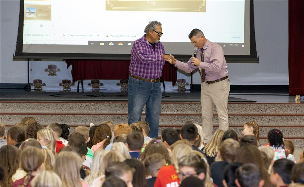 Principal Andy Morgan presents special guests at their 10th Anniversary event.